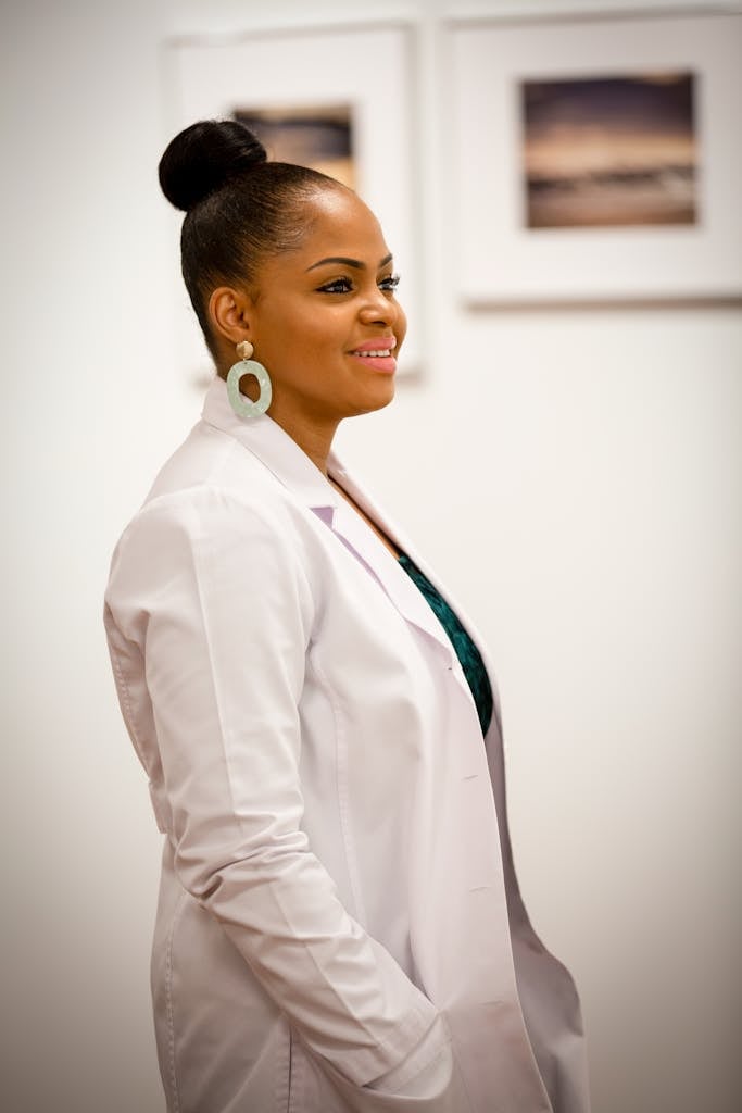 Portrait of a smiling female doctor in a white coat, exuding professionalism and confidence.